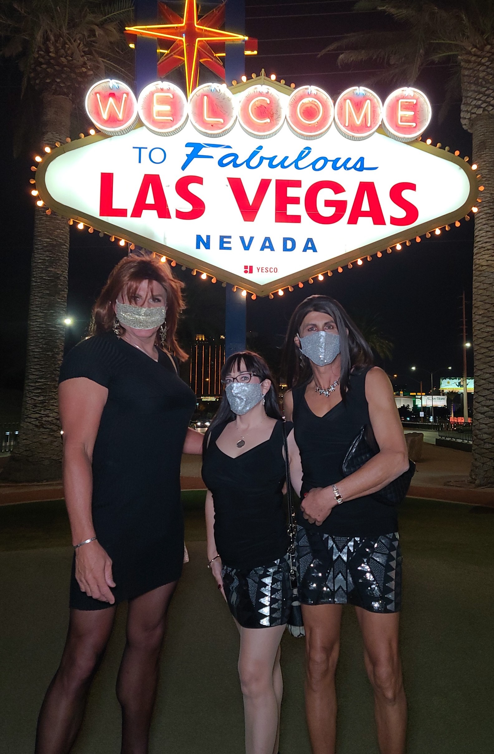 Three people in front of Las Vegas sign